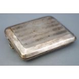 An Art Deco silver rectangular form engine turned decorated cigarette case,