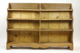 A pine waterfall style standing double bookcase,