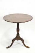 A 19th century mahogany tilt top table on turned pedestal on cabriole legs,