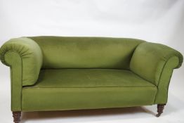 A late 19th century two seat sofa with one drop end on turned tapering legs,