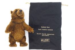 A Steiff Kodiak bear with button and label to the ear, 26cm tall,