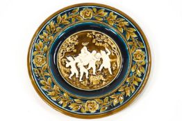 An Austrian majolica charger, decorated in brown turquoise and green in relief,