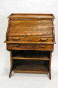 A small oak bureau with tambour front above one drawer and two open shelves,