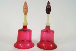 Two Victorian glass bells, each with cranberry tinted bodies,