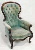 A Victorian mahogany show frame armchair, with button back and carved cabriole legs,