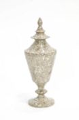 A polished serpentine urn and Pagoda style cover,