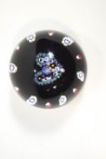 A Caithness Heart paperweight, the cane motifs including profiles,