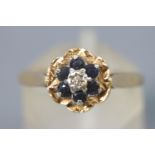 A collection of two yellow metal rings to include: A yellow/white three stone diamond ring,