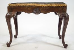 A 18th century style mahogany stool with inset tapestry seat,