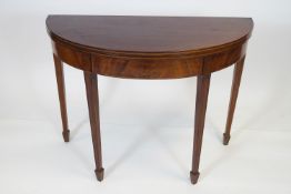 A George III mahogany demi-lune tea table,