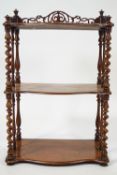 A Victorian walnut what not with pierced back and barley twist supports,