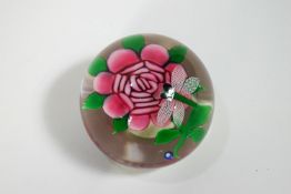 A Joan Deacon Rose paperweight with applied paper label,
