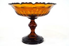 An amber glass comport with shallow bowl top cut with a crenellated edge,