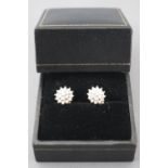 A yellow and white metal pair of diamond cluster stud earrings.