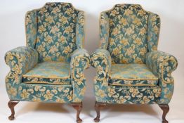 A pair of Queen Anne style armchairs with loose cushions, on cabriole legs,