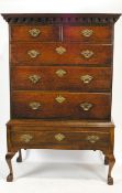 A George III oak chest of two short and three long drawers, on later stand,