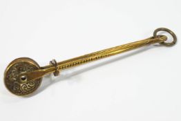 A Victorian dress lifter in brass, by Plant and Green,