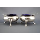 A pair of silver cauldron salts with rope twist edges raised on three cabriole legs