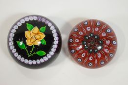 A Caithness paperweight with millefiori cane work and a yellow rose,