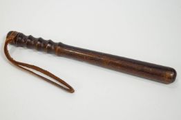 A rosewood truncheon, 39cm long, stamped with a crown and the initials MP,
