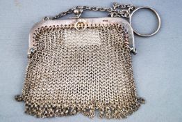 A silver mesh purse, of squared usual form, on a suspension chain with ring attachment,