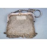 A silver mesh purse, of squared usual form, on a suspension chain with ring attachment,