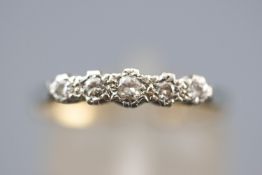 A yellow and white metal five stone diamond ring. Estimated total weight of 0.15cts.