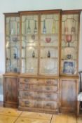 A 19th century mahogany breakfront bookcase, the central section with four graduated drawers,