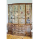 A 19th century mahogany breakfront bookcase, the central section with four graduated drawers,