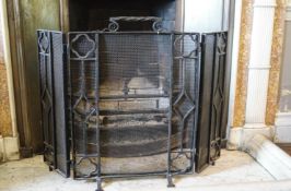 A wrought iron triple fire guard,