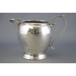 A silver three piece tea service of plain rounded form, with reeded tops and bases,