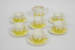 A Solian ware coffee set with six cups and saucers and a jug, decorated with yellow foliate motifs,