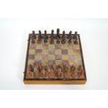 An Indian carved soapstone chess set with figures in the style of the Qutub Minar in Delhi,