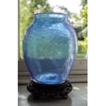 Two soda glass vases, one in blue on Chinese hardwood stand,