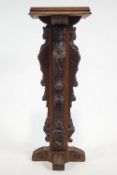 An oak torchere, the column carved in Jacobean style,