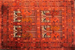 A Tekka Turkoman rug with central quartered panels enclosing geometric motifs