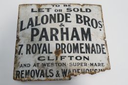 An enamel sign, "To Be Let or Sold Lalonde Bros. & Parham, 7 Royal Promenade Clifton...