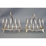 A pair of small silver four slice toast racks, with round handles and dividers,