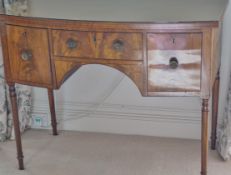 A 19th century bow fronted dressing table with three drawers on turned tapering legs,