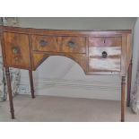 A 19th century bow fronted dressing table with three drawers on turned tapering legs,
