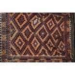 A Kilim rug, with multicoloured lozenge ground within thre boarders,