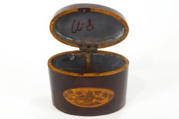 A late 18th century oval mahogany tea caddy, inlaid with baskets of flowers,