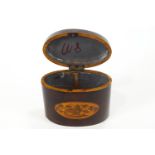 A late 18th century oval mahogany tea caddy, inlaid with baskets of flowers,