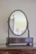 A 19th century mahogany swing frame mirror with one single drawer on ogee bracket feet,