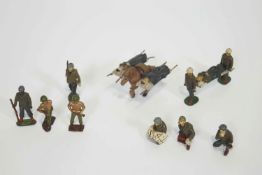 A group of late WWII cast metal American model soldiers, to include two African Americans,
