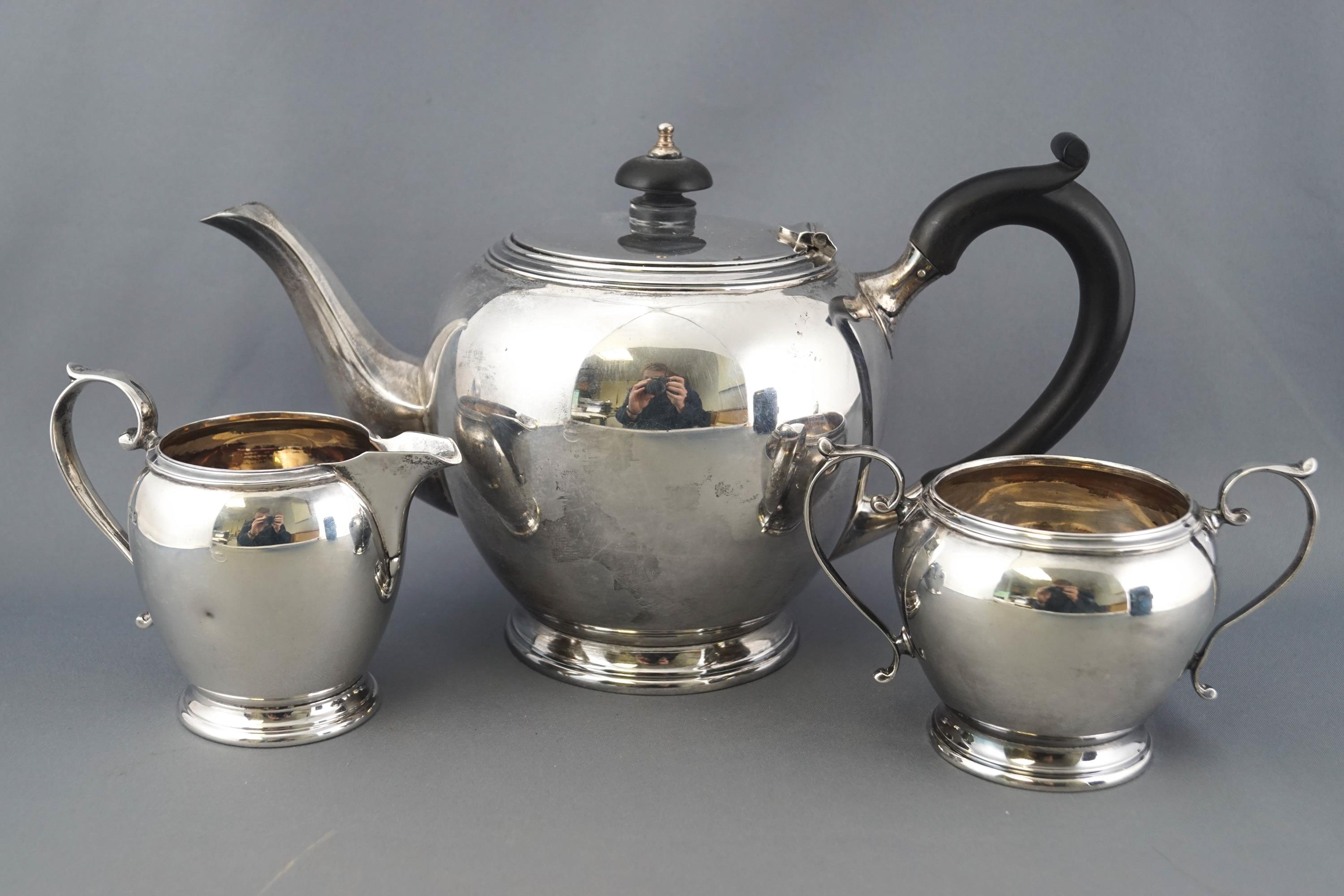 A silver three piece tea service of plain rounded form, with reeded tops and bases, - Image 2 of 5