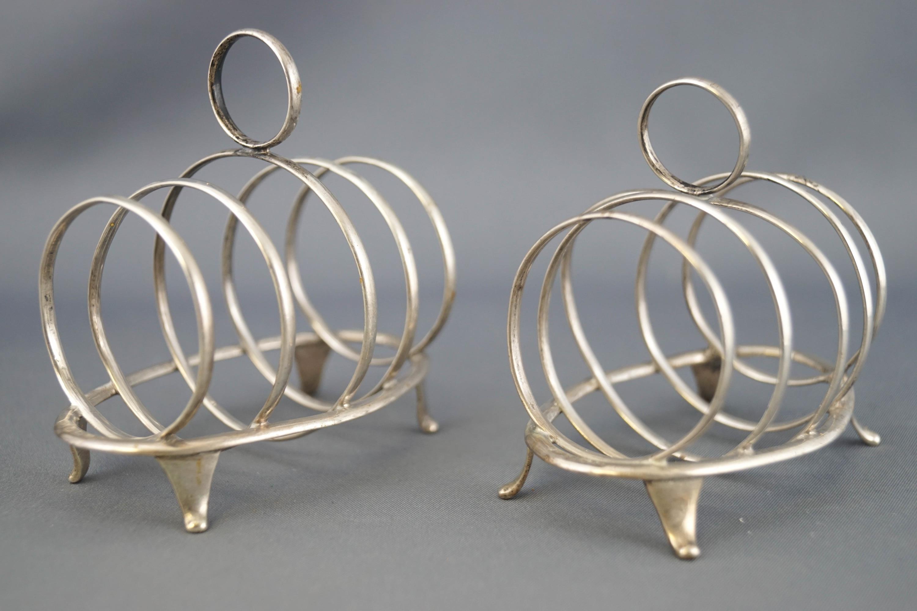 A pair of small silver four slice toast racks, with round handles and dividers, - Image 2 of 2