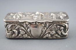 A silver vesta, decorated in the Dutch repousse style with a tavern scene and foliate scrolling,