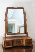 A 17th century style walnut swing frame mirror, the shaped base with three drawers,
