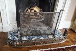 An 18th century cut steel fender together with a wrought iron fire guard,